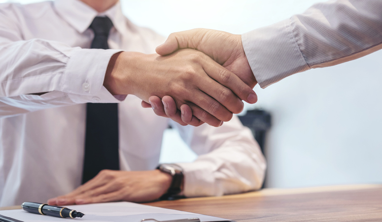 Tenant & real estate agent shaking hands after making a deal